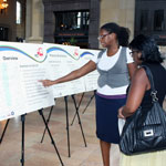 consultant talks with public meeting attendee at Union Station