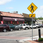 parked cars and crosswalk sign in downtown Overland Park