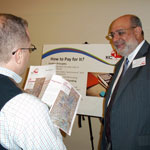 study team member talks about potential financing options with open house attendee